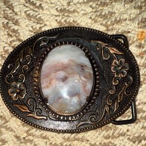 Western-style belt buckle with an oval, polished stone center Beautiful